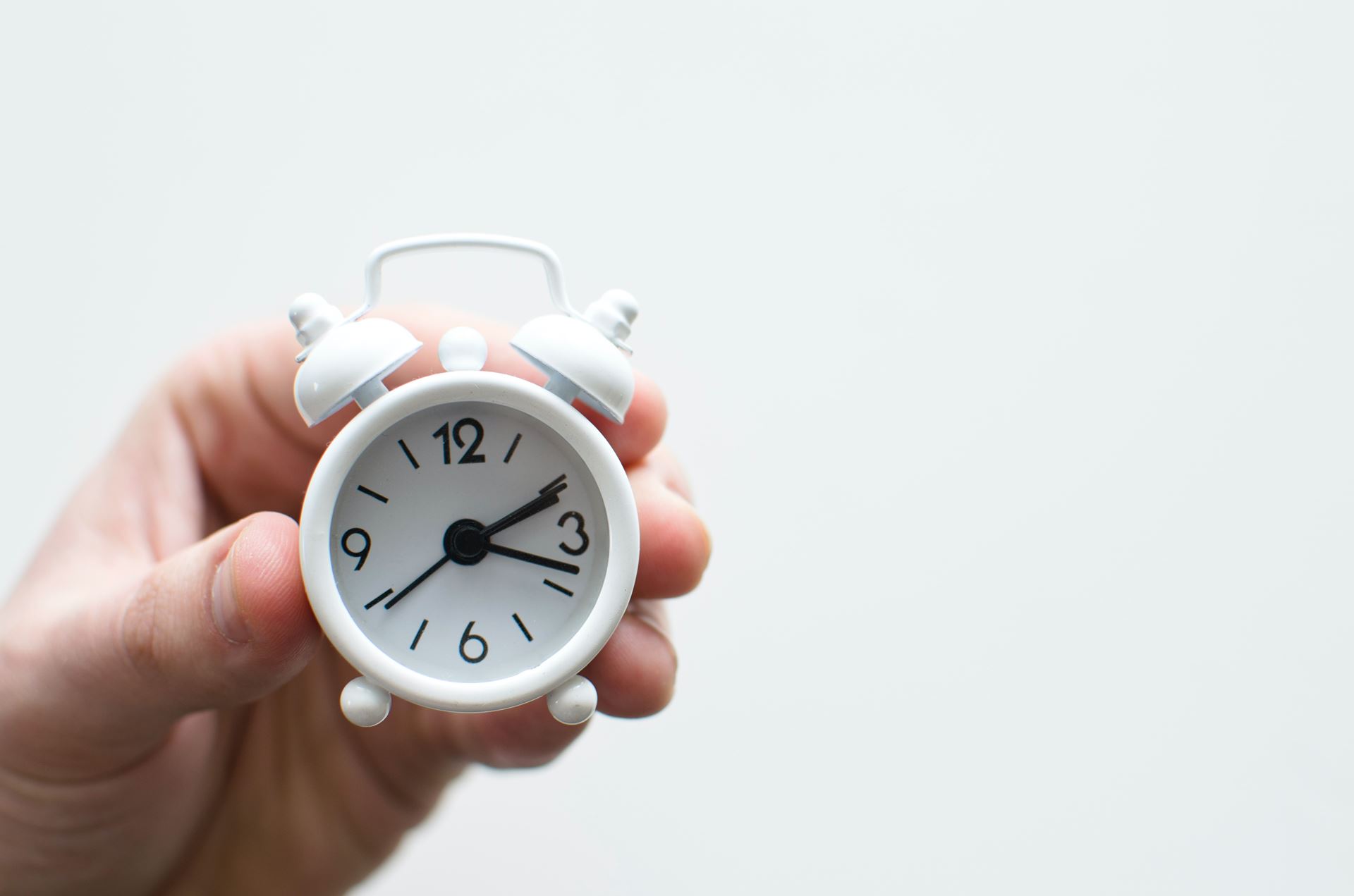 a person holding a clock