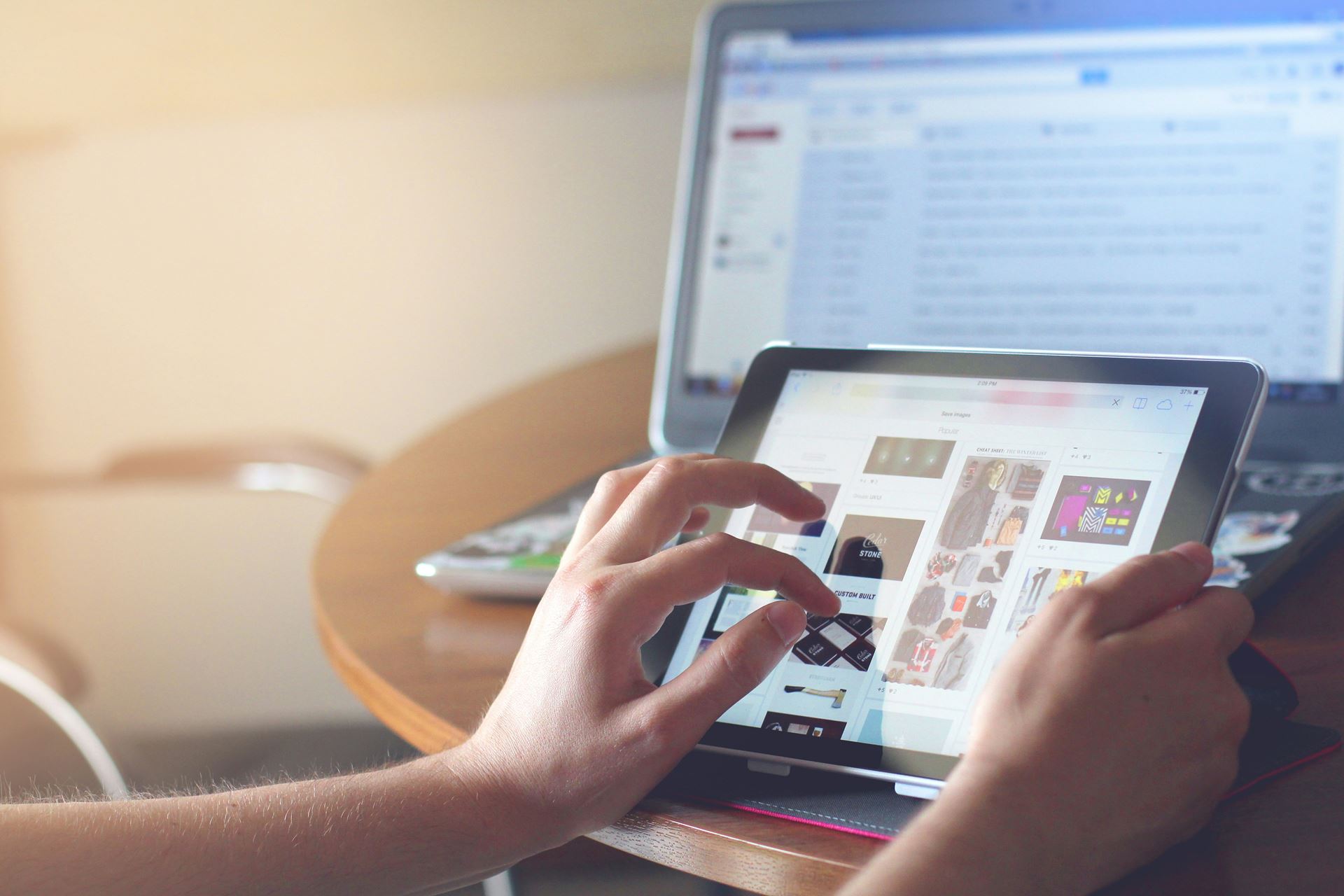 a person holding a mobile device - a tablet